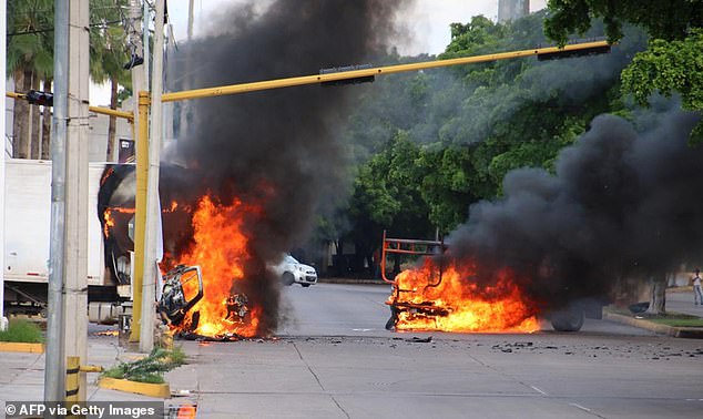 19865906 7586525 Vehicles Burn In A Street Of Culiacan State Of Sinaloa Mexico On A 115 1571372375970