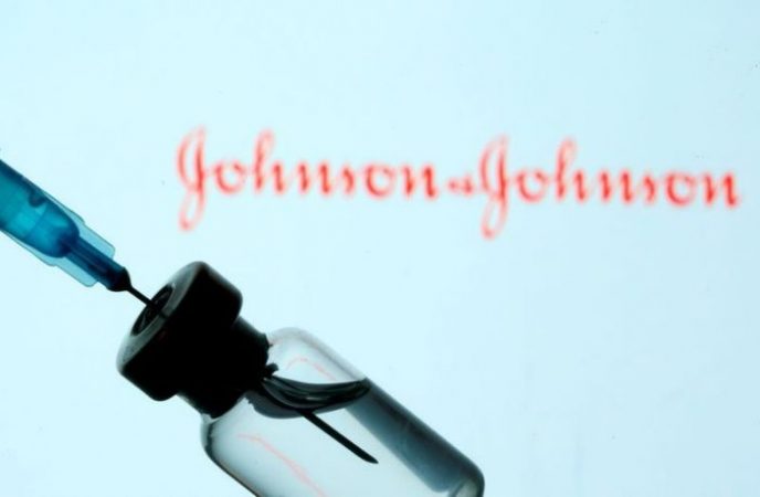 File Photo: Vial And Syringe Are Seen In Front Of Displayed Johnson&johnson Logo In This Illustration