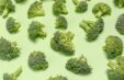Broccoli Pieces On Green Surface 1000x650