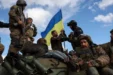 Ukrainian Soldiers Adjust National Flag