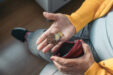 Close Up,aerial,image,of,a,seated,older,woman's,hand,holding